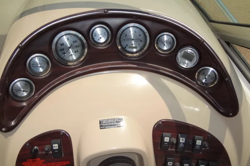 Slide: The Image of Dashboard of a 2000 Chaparral Signature 260 boat with gauges and controls. - 13