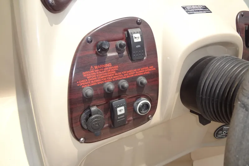 Slide: The Image of Control panel of 2000 Chaparral Signature 260 boat with warning labels and switches. - 14
