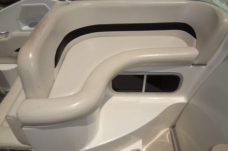 Slide: The Image of 2000 Chaparral Signature 260 boat interior with white cushioned seating. - 16