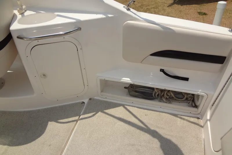 Slide: The Image of 2000 Chaparral Signature 260 boat interior with storage compartment and clean white finish. - 19