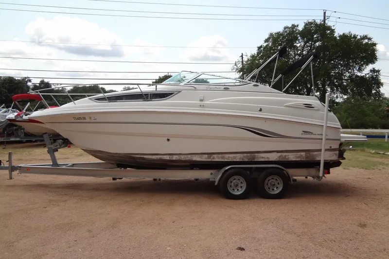 Slide: The Image of 2000 Chaparral Signature 260 boat on trailer, parked outdoors. - 2