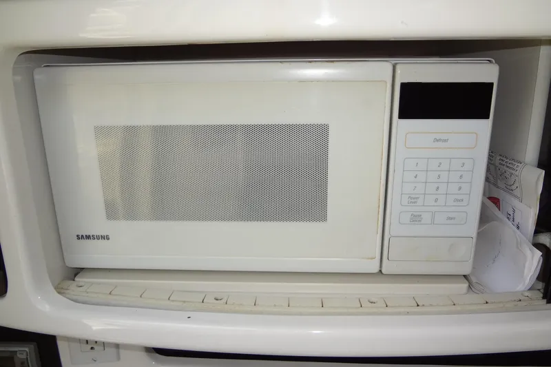 Slide: The Image of Samsung microwave inside a 2000 Chaparral Signature 260 boat kitchen area. - 23