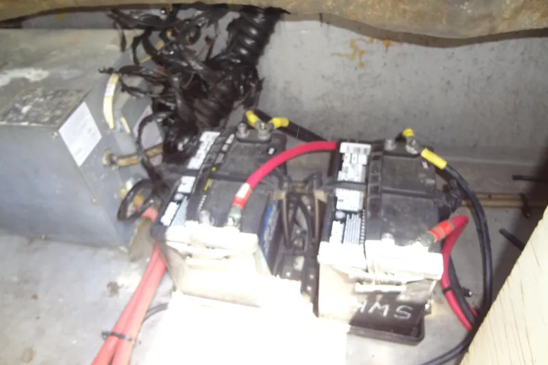 Slide: The Image of Battery compartment of a 2000 Chaparral Signature 260 boat with wiring and connections. - 29