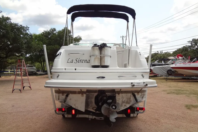 Slide: The Image of Rear view of 2000 Chaparral Signature 260 boat named "La Sirena" in a yard setting. - 4