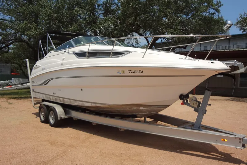 Slide: The Image of 2000 Chaparral Signature 260 boat on trailer, parked outdoors. - 7