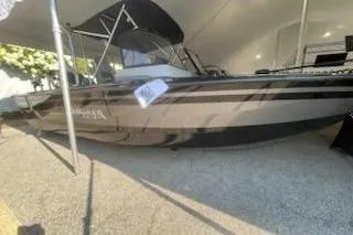 Slide: The Image of 2026 Smoker Craft 210 GLS SPORT boat displayed in a showroom. - 7