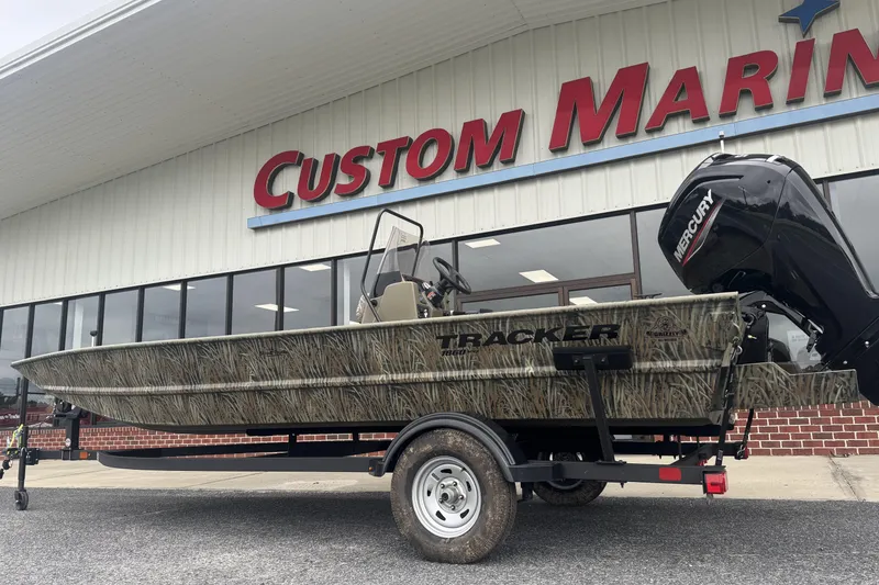 The Image of 2026 Tracker Grizzly 1860 CC boat on trailer outside Custom Marine store. - 0