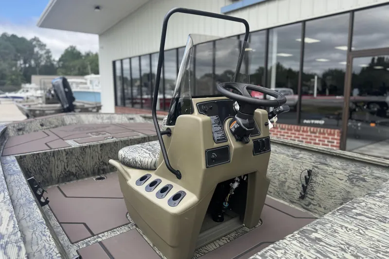Slide: The Image of 2026 Tracker Grizzly 1860 CC boat with camo design and steering console. - 3