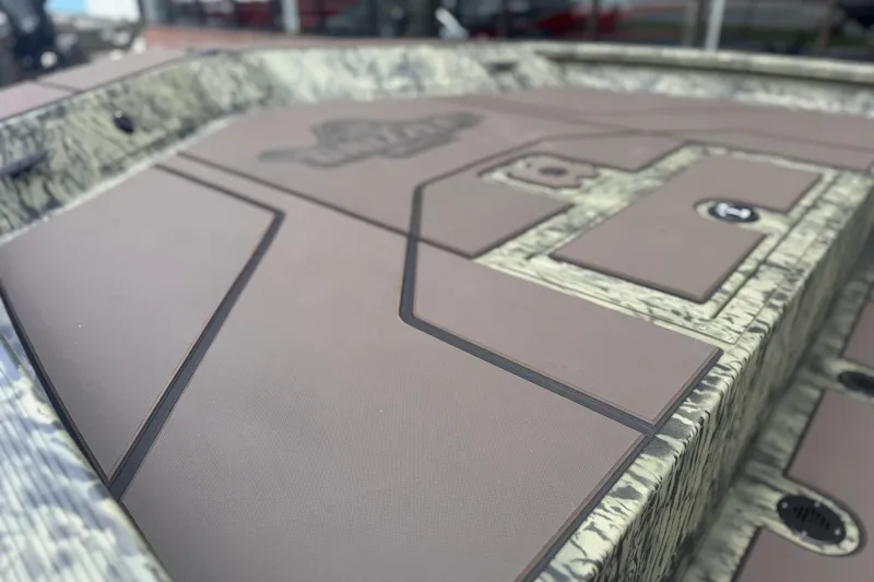 Slide: The Image of 2026 Tracker Grizzly 1860 CC boat deck with camouflage pattern and storage compartments. - 7