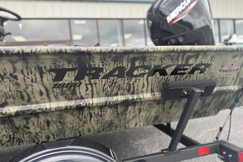 Slide: The Image of 2026 Tracker Grizzly 1860 CC boat with camouflage design and Mercury engine. - 8