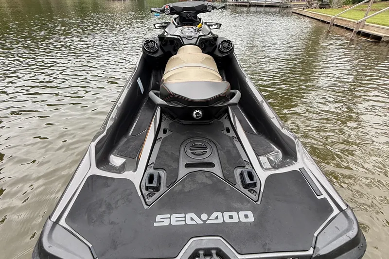 Slide: The Image of 2021 Sea-Doo GTX 230 jet ski on calm water, showcasing sleek design and seating. - 3