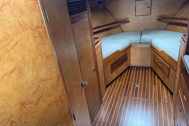 Slide: The Image of 1979 Pacific Bluefin Sportfisher cabin interior with wood paneling and cushioned seating. - 10