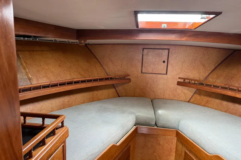 Slide: The Image of 1979 Pacific Bluefin Sportfisher cabin interior with wooden shelves and cushioned seating. - 11