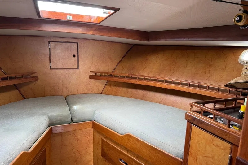 Slide: The Image of Cozy cabin interior of a 1979 Pacific Bluefin Sportfisher boat with wooden accents. - 12