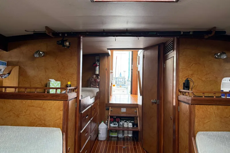 Slide: The Image of Interior of a 1979 Pacific Bluefin Sportfisher boat with wooden furnishings and storage. - 13