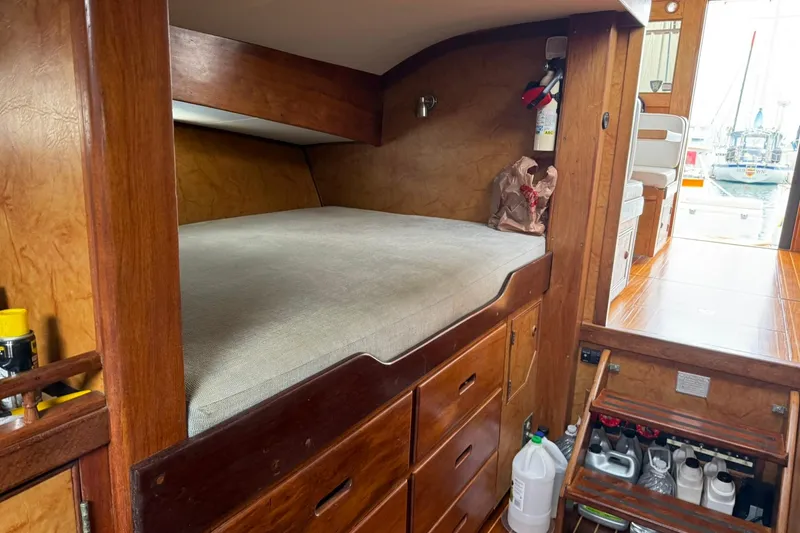 Slide: The Image of Cozy cabin interior of a 1979 Pacific Bluefin Sportfisher boat with wooden furnishings. - 14