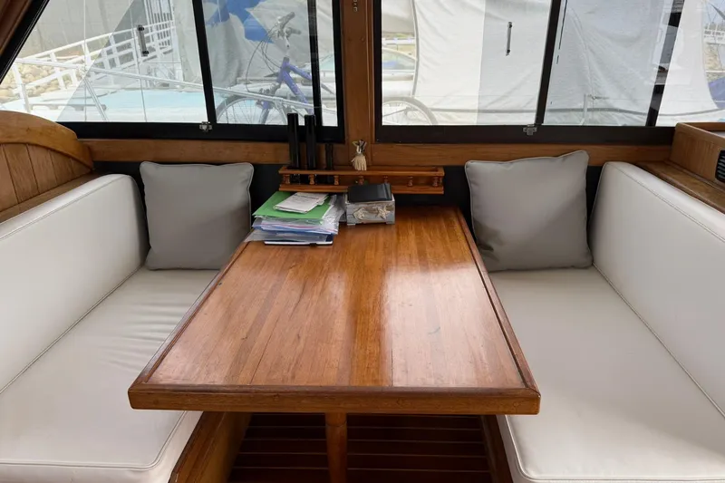Slide: The Image of Interior of 1979 Pacific Bluefin Sportfisher with wooden table and white cushioned seating. - 17