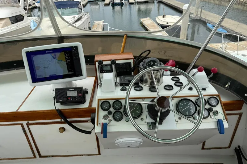 Slide: The Image of 1979 Pacific Bluefin Sportfisher helm with navigation equipment and steering wheel at marina. - 21