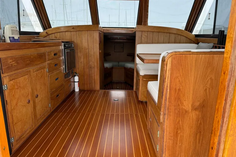 Slide: The Image of Interior of a 1979 Pacific Bluefin Sportfisher boat with wooden cabinetry and seating. - 3