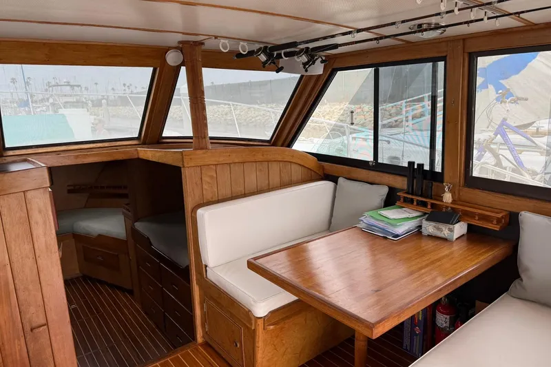 Slide: The Image of Interior of a 1979 Pacific Bluefin Sportfisher boat with wooden furnishings and seating area. - 6