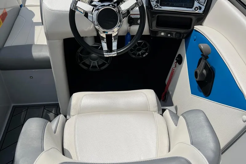 Slide: The Image of Interior of 2016 Tigé Z1 boat with steering wheel and control panel. - 10
