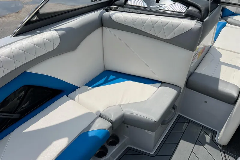 Slide: The Image of 2016 Tigé Z1 boat interior with gray and blue cushioned seating. - 11