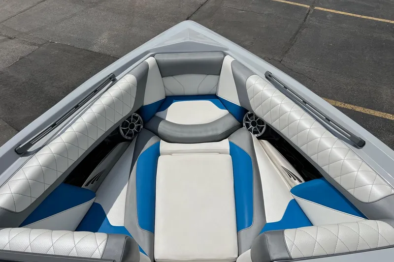 Slide: The Image of 2016 Tigé Z1 boat interior with blue and white cushioned seating. - 12