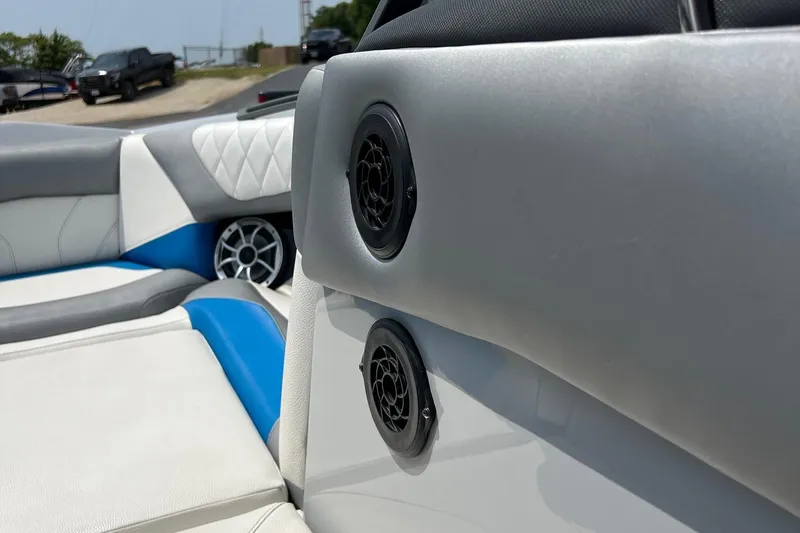 Slide: The Image of 2016 Tigé Z1 boat interior with speakers and blue-white seating. - 13