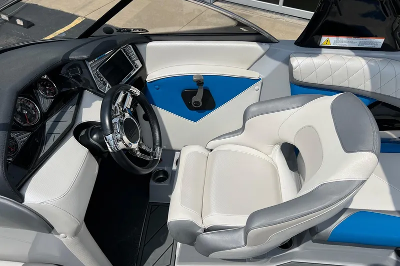 Slide: The Image of Interior of a 2016 Tigé Z1 boat featuring a sleek steering wheel and modern dashboard. - 14