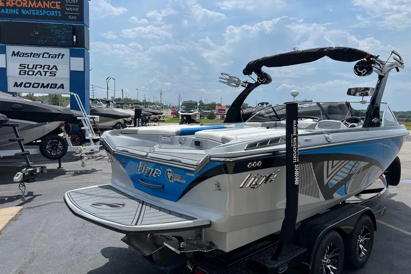 Slide: The Image of 2016 Tigé Z1 boat displayed at a marine dealership under a clear sky. - 5