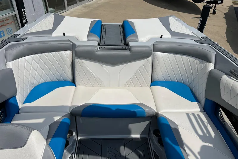 Slide: The Image of 2016 Tigé Z1 boat interior with white, blue, and gray seating. - 9