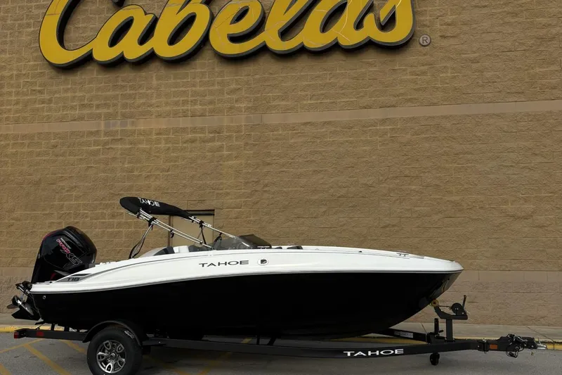 Slide: The Image of 2026 Tahoe TAHT18 boat on trailer outside Cabela's store. - 2