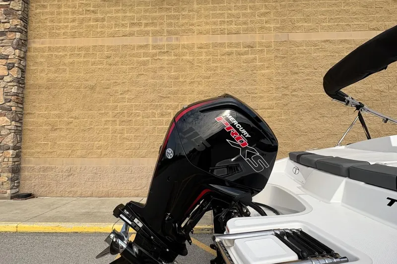 Slide: The Image of 2026 Tahoe TAHT18 boat with Mercury Pro XS engine, parked by a brick wall. - 5