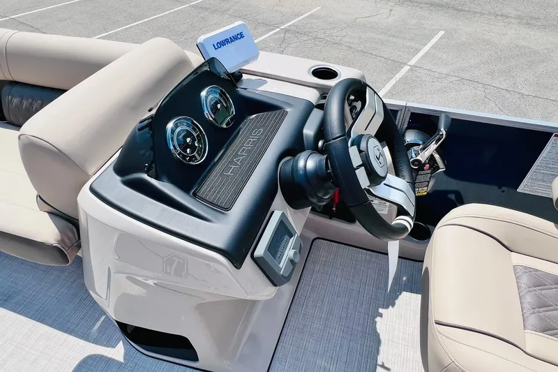 Slide: The Image of 2026 Harris Cruiser Sunliner 250 CW boat dashboard with steering wheel and gauges. - 19