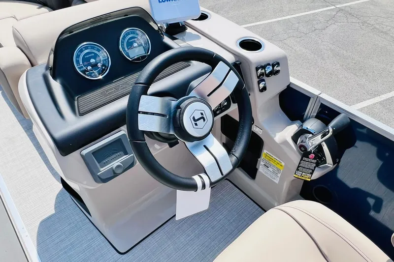 Slide: The Image of Steering console of 2026 Harris Cruiser Sunliner 250 CW 200HP boat, featuring modern controls. - 20
