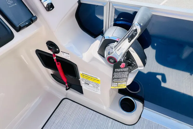 Slide: The Image of Control panel of 2026 Harris Cruiser Sunliner 250 CW 200HP boat with throttle and safety features. - 26