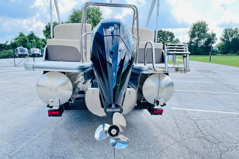 Slide: The Image of 2026 Harris Cruiser Sunliner 250 CW 200HP boat, rear view with powerful outboard motor. - 36