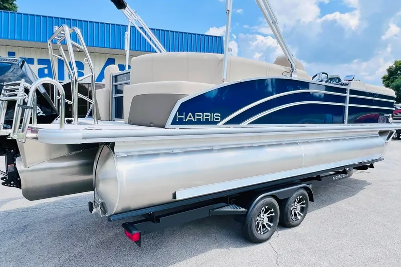 Slide: The Image of 2026 Harris Cruiser Sunliner 250 CW 200HP pontoon boat on trailer, blue and silver design. - 39