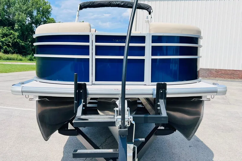 Slide: The Image of 2026 Harris Cruiser Sunliner 250 CW 200HP pontoon boat on trailer, front view. - 4