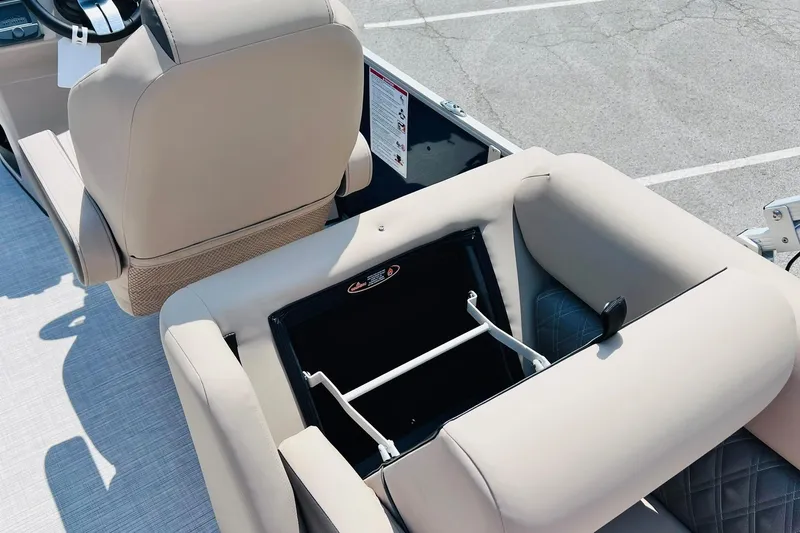 Slide: The Image of 2026 Harris Cruiser Sunliner 250 CW boat interior with beige seating and storage compartment. - 41