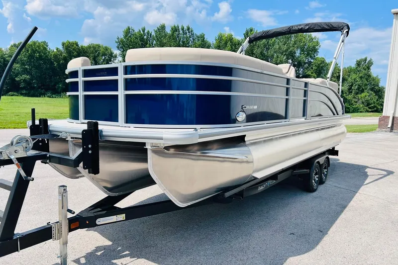 Slide: The Image of 2026 Harris Cruiser Sunliner 250 CW 200HP pontoon boat on trailer, outdoors. - 6