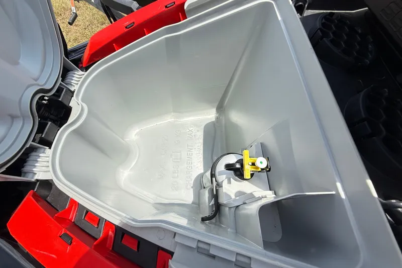 Slide: The Image of 2014 Sea-Doo RXT-X 260 storage compartment, open and empty, with visible latch mechanism. - 10