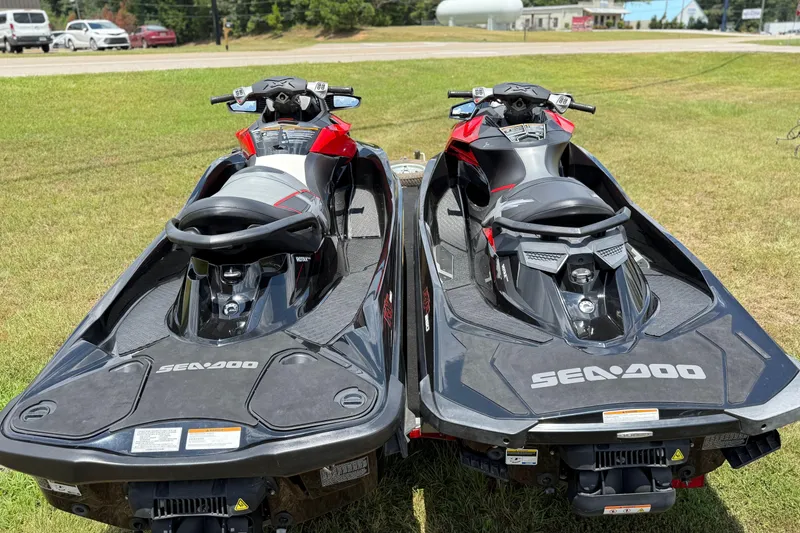 Slide: The Image of Two 2014 Sea-Doo RXT-X 260 jet skis on grass, rear view. - 13