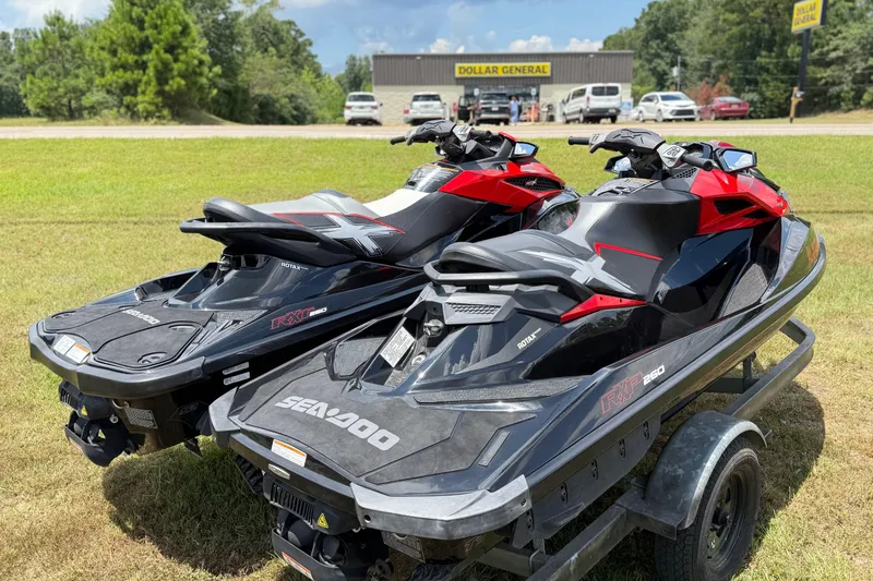 Slide: The Image of 2014 Sea-Doo RXT-X 260 jet skis on trailer near Dollar General store. - 16