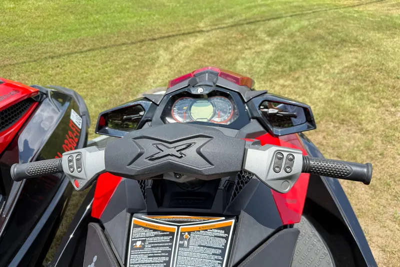 Slide: The Image of 2014 Sea-Doo RXT-X 260 handlebars and dashboard, parked on grass. - 18