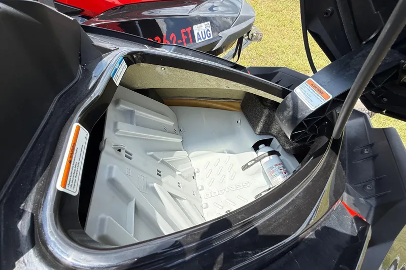 Slide: The Image of Open storage compartment of 2014 Sea-Doo RXT-X 260 watercraft, showing interior details. - 21