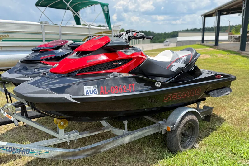 Slide: The Image of 2014 Sea-Doo RXT-X 260 jet ski on trailer, parked on grass. - 3
