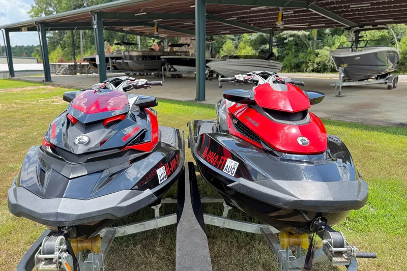Slide: The Image of Two 2014 Sea-Doo RXT-X 260 jet skis on trailers, parked outdoors. - 7