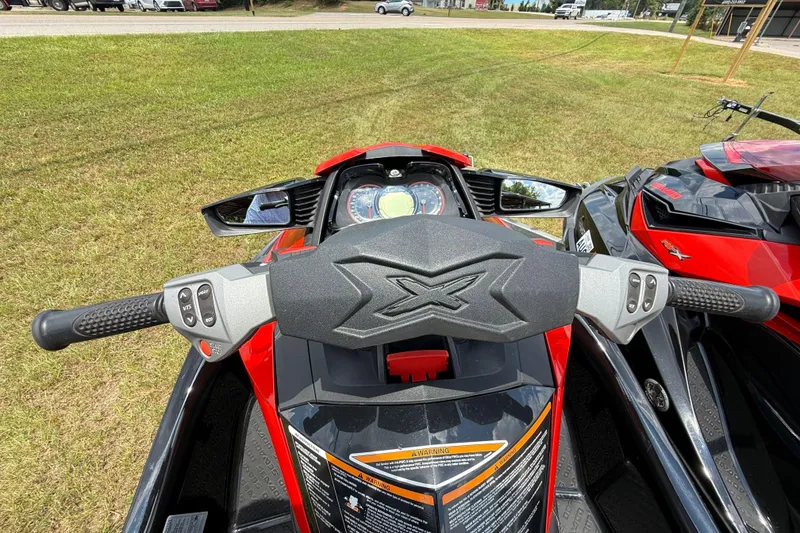 Slide: The Image of 2014 Sea-Doo RXT-X 260 handlebars and dashboard, parked on grass. - 9