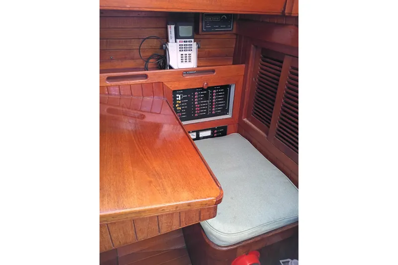 Slide: The Image of 1978 Baba Cutter interior with wooden navigation station and communication equipment. - 18